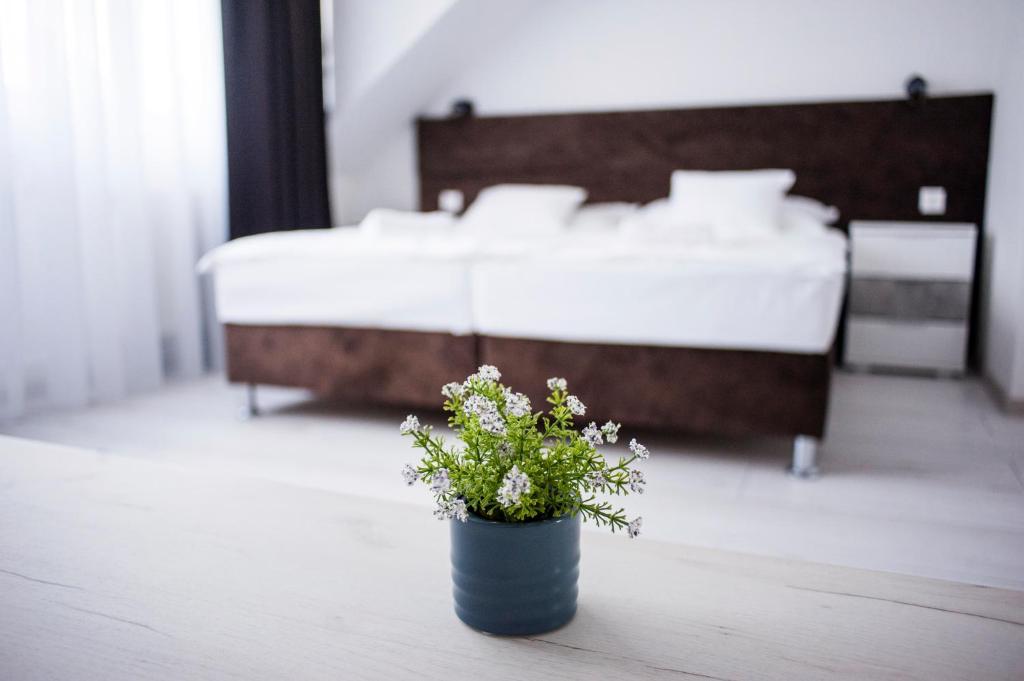 A bed or beds in a room at Q-Panzió