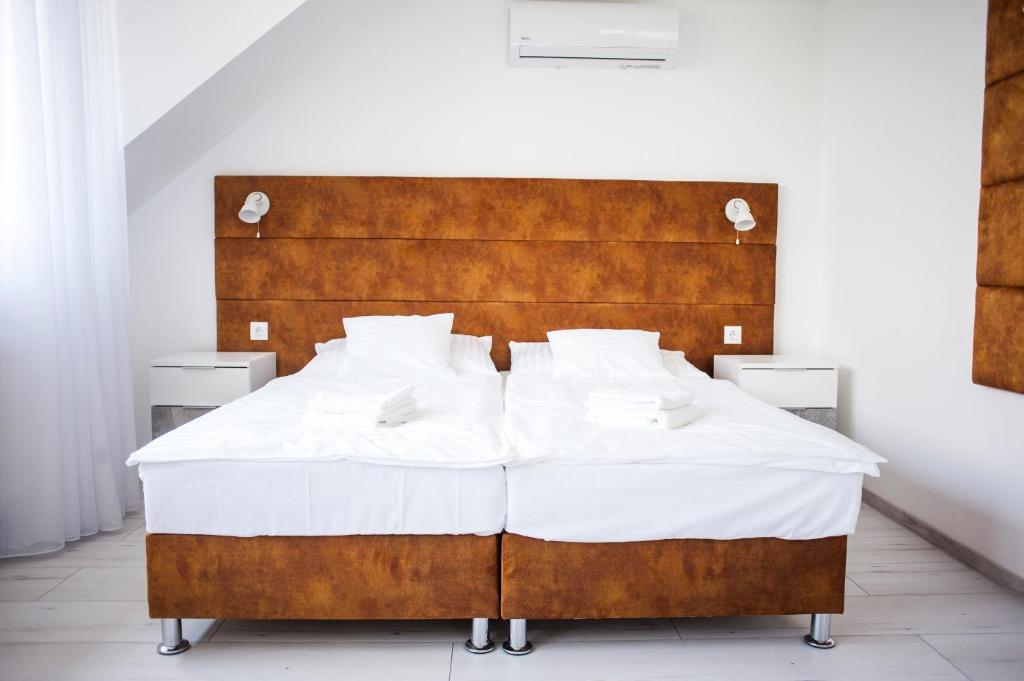 A bed or beds in a room at Q-Panzió