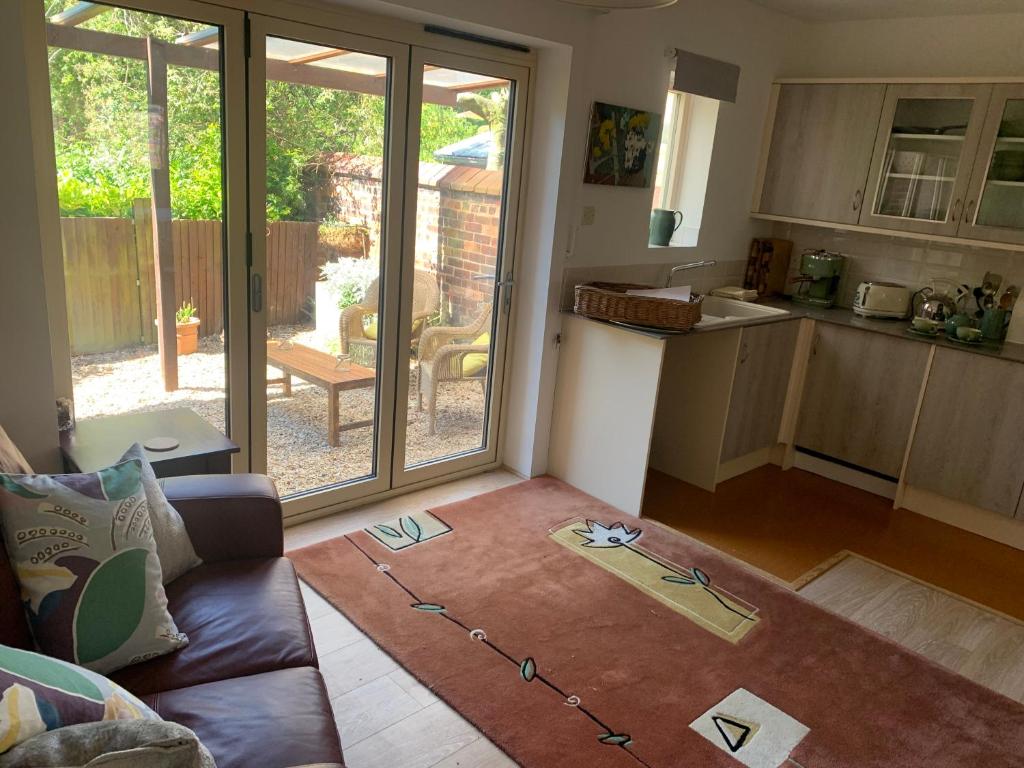 a living room with a couch and a kitchen at Top Studio in Lincoln