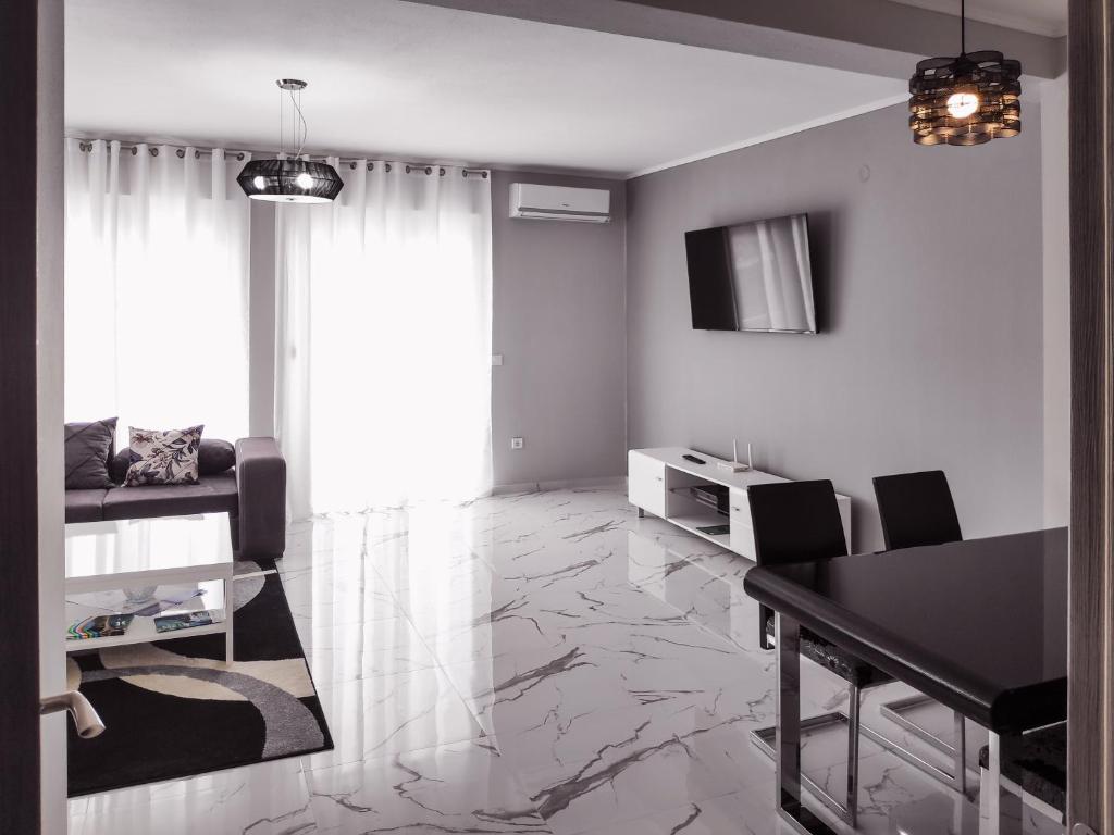 a living room with a dining table and a living room with a television at Adriatic Oasis in Bar
