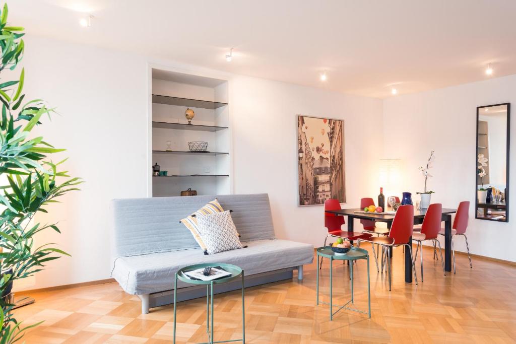 a living room with a couch and a table at HITrental Chapel Bridge Apartments in Lucerne