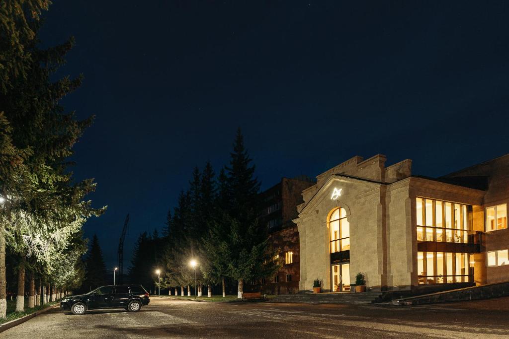 a car parked in front of a building at night at Jermuk Ashkhar Sanatorium in Jermuk