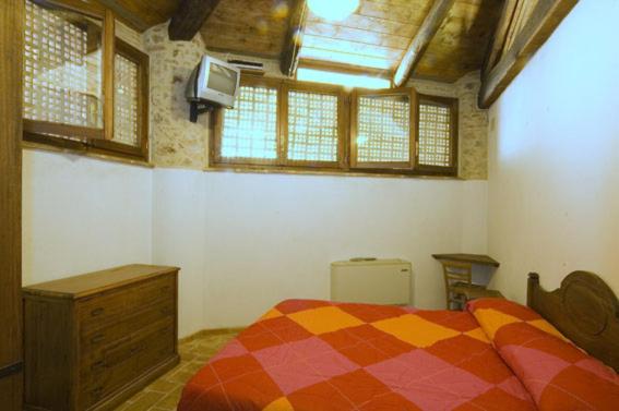 Postel nebo postele na pokoji v ubytování Agriturismo I Sassi Grossi