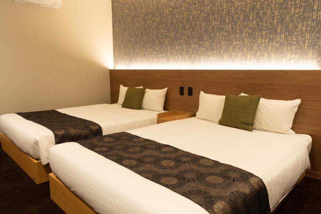 Postel nebo postele na pokoji v ubytování Chiyokura HOTEL SHUKU Nagoya