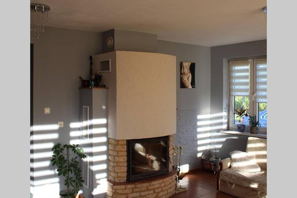 a living room with a fire place in a living room at Dom nad Morzem in Gąski