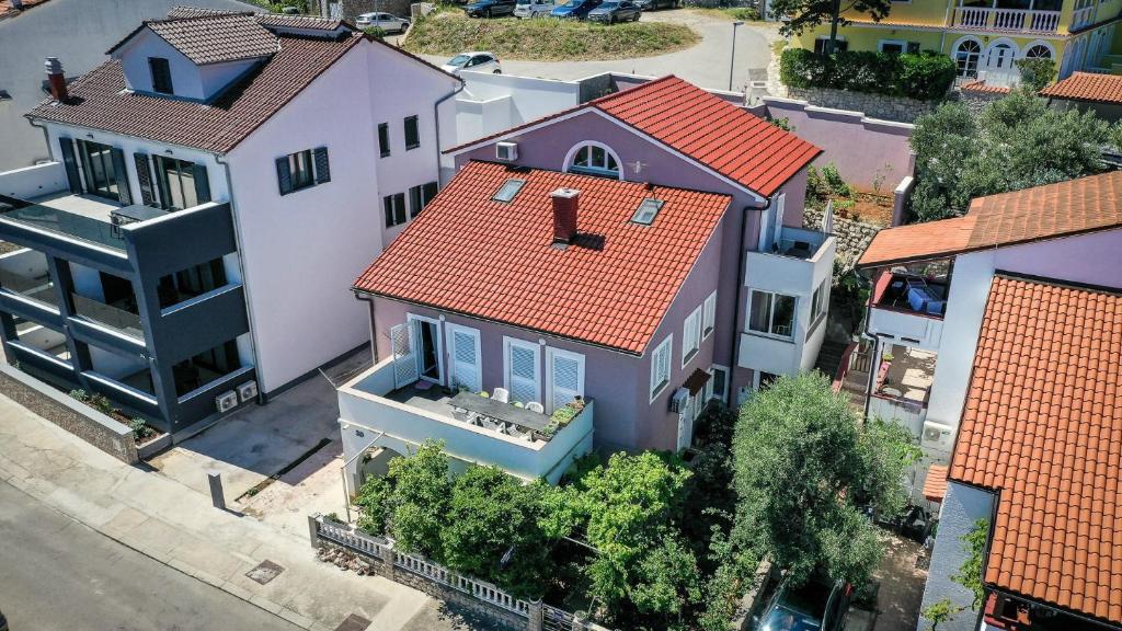 an overhead view of a house with an orange roof at Apartments Jelena, Mali Lošinj in Mali Lošinj