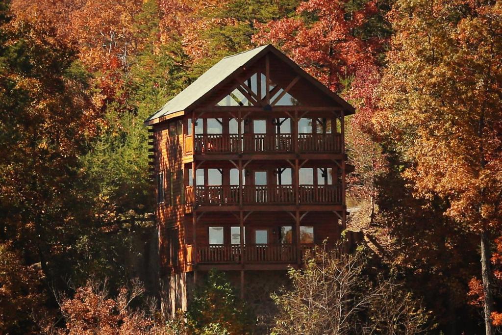 a large wooden house in the middle of a forest at His Amazing Grace in Sevierville