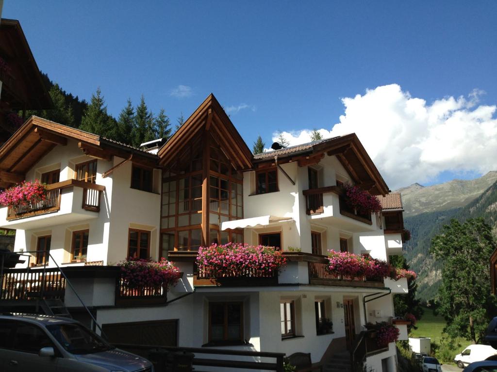a building with flowers in the balconies on it at Apart Christa in Kaunertal
