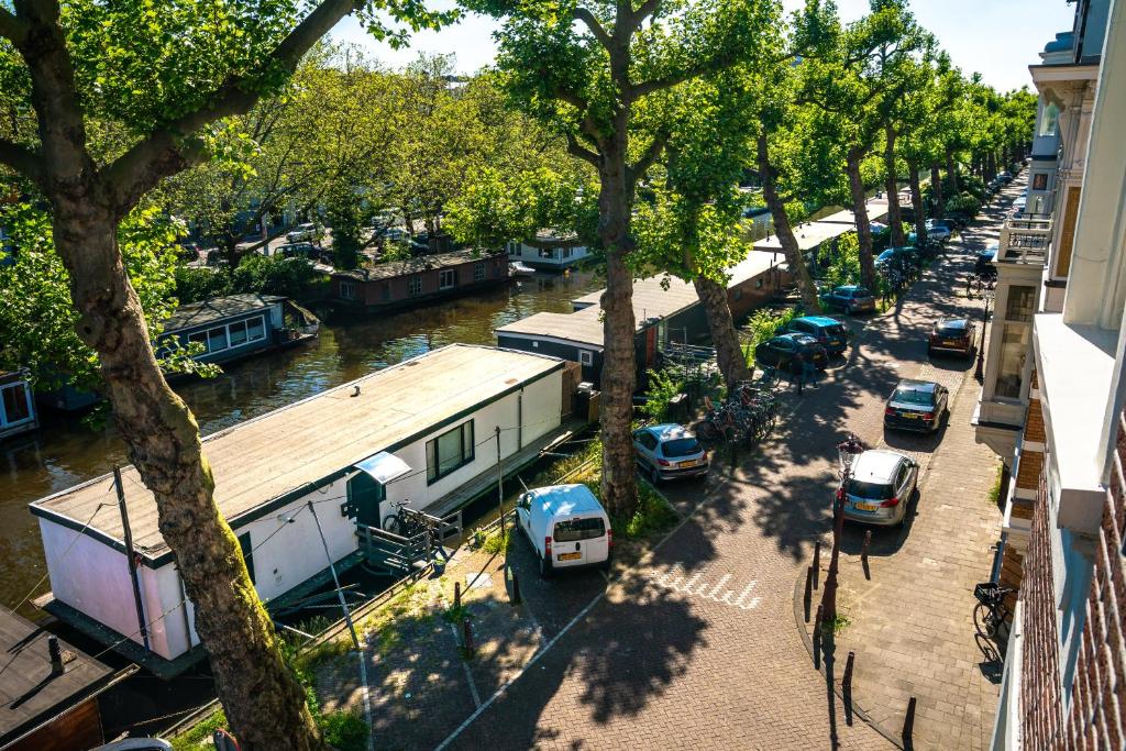 an aerial view of a canal with parked cars and houses at Amsterdam-Houseboat-Amstel in Amsterdam
