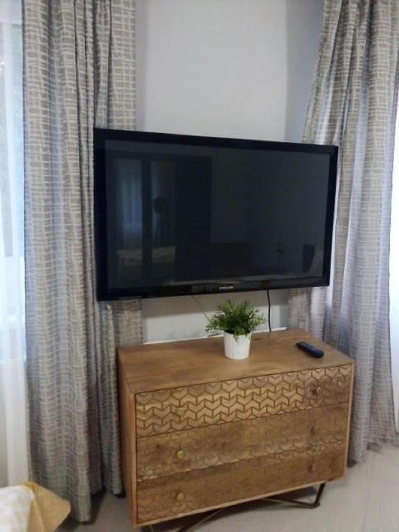 Televízia a/alebo spoločenská miestnosť v ubytovaní Apartman Ráchegy