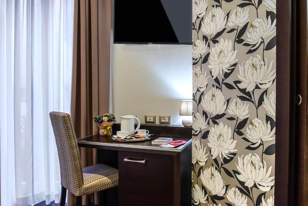 a room with a desk and a chair in a room at Catone District Hotel in Rome