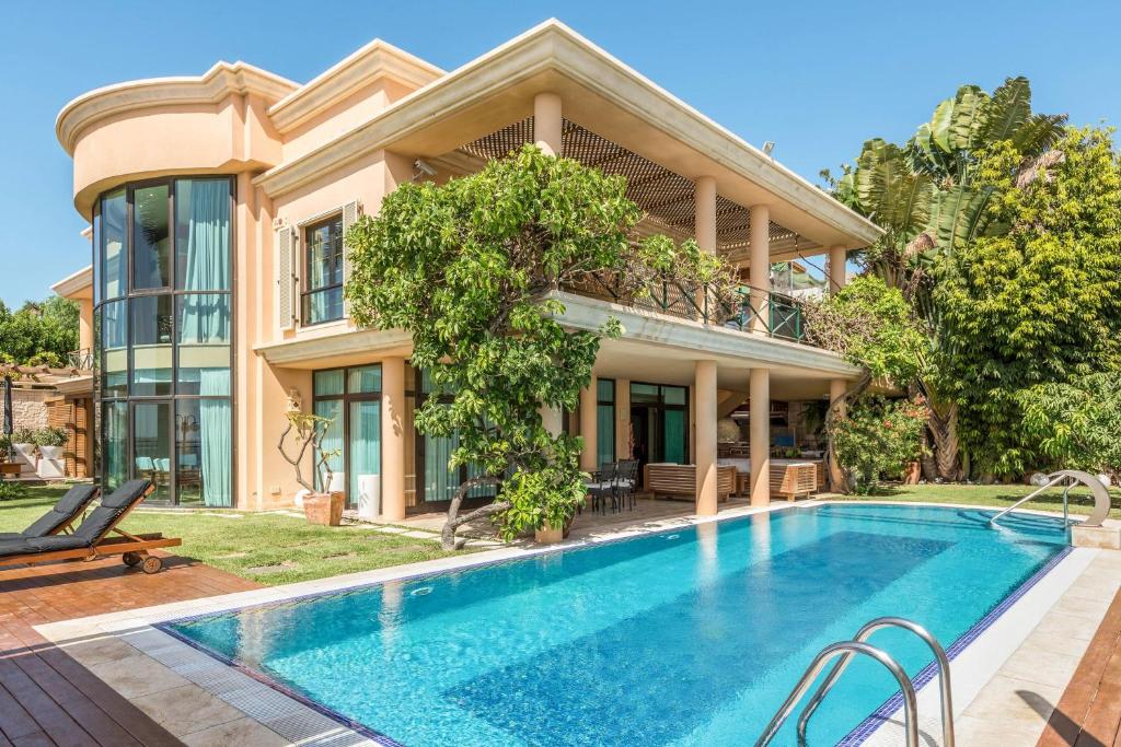 een huis met een zwembad ervoor bij Villa Albella in San Agustin