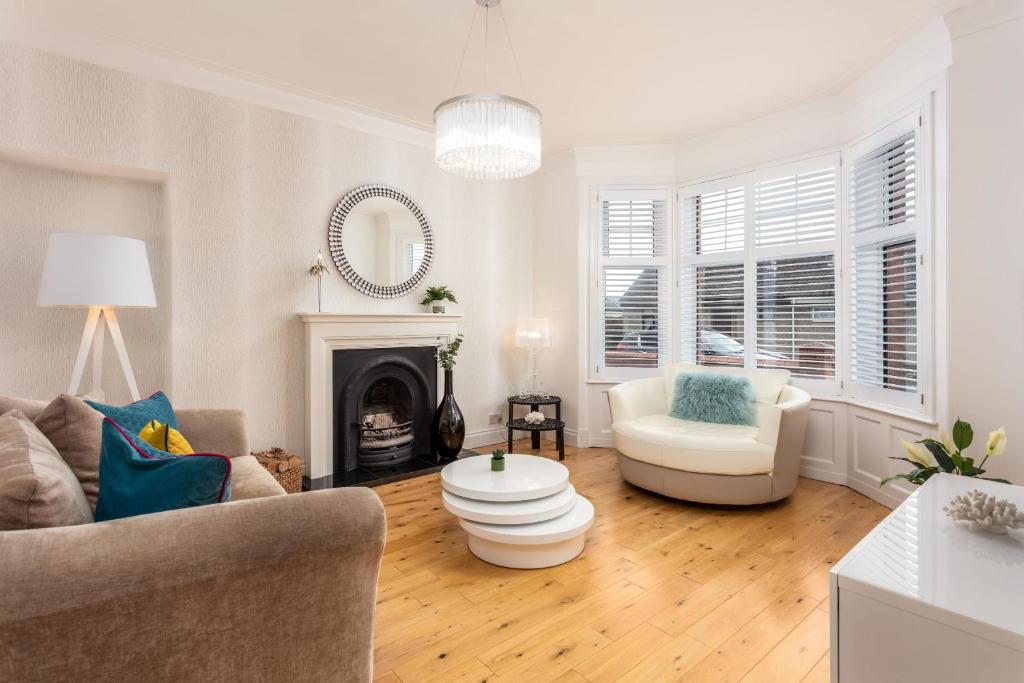 a living room with a couch and a fireplace at Rothiemay House - Donnini Deluxe in Prestwick