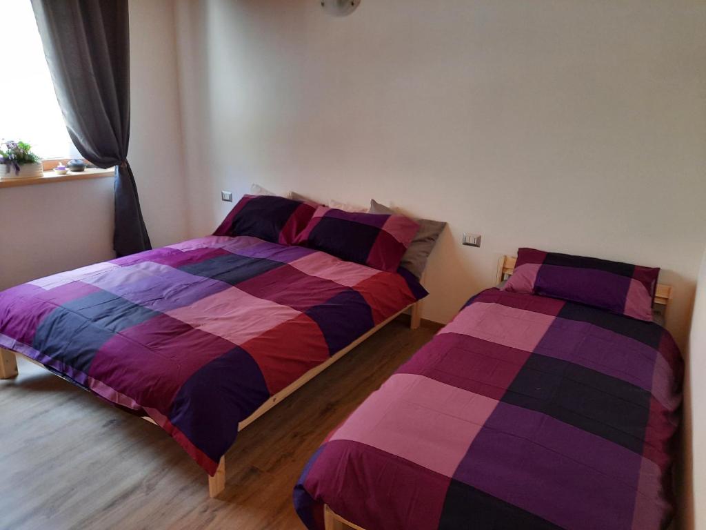 Postel nebo postele na pokoji v ubytování Ai Monti