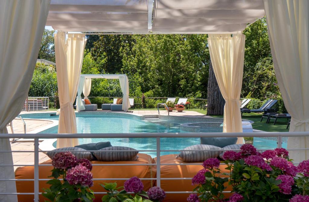 a view of a pool with a couch in front at Hotel St.Mauritius in Forte dei Marmi