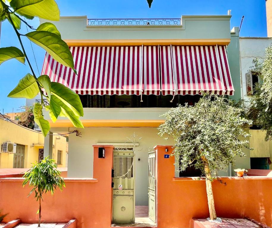 a house with an orange door and a flag at K8 Athens in Athens