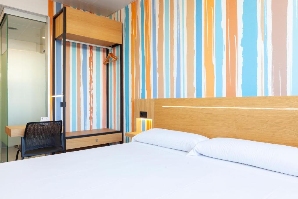 Cama o camas de una habitación en Vértice Roomspace