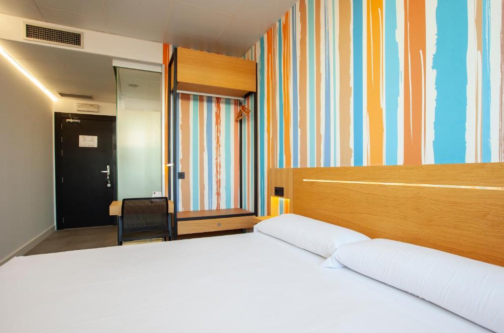 Cama o camas de una habitación en Vértice Roomspace