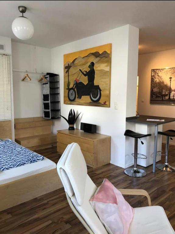 1 dormitorio con 1 cama y una pintura de motocicleta en la pared en Ferienwohnung Zwergmöwe, en Rostock