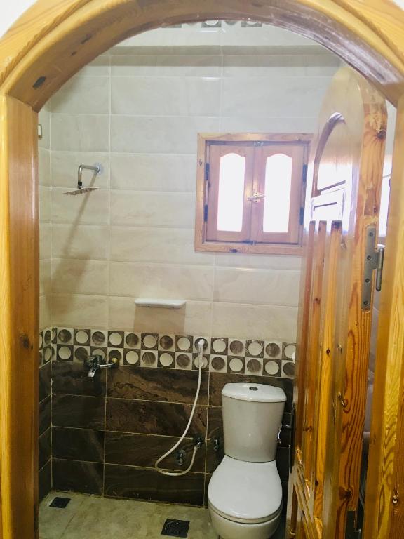 a bathroom with a toilet and a window at Villa 22 in Dahab