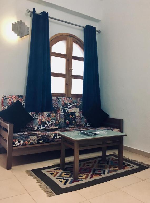 a couch with a table in front of a window at Villa 22 in Dahab