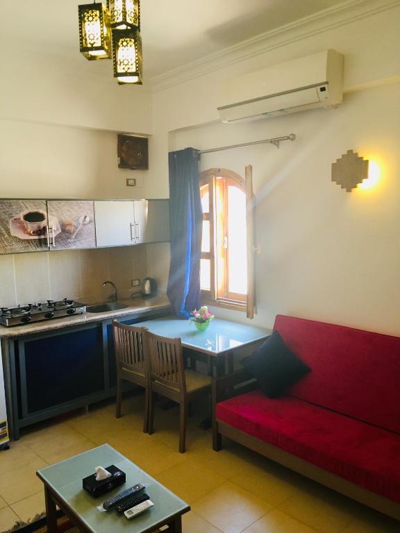 a living room with a red couch and a table at Villa 22 in Dahab