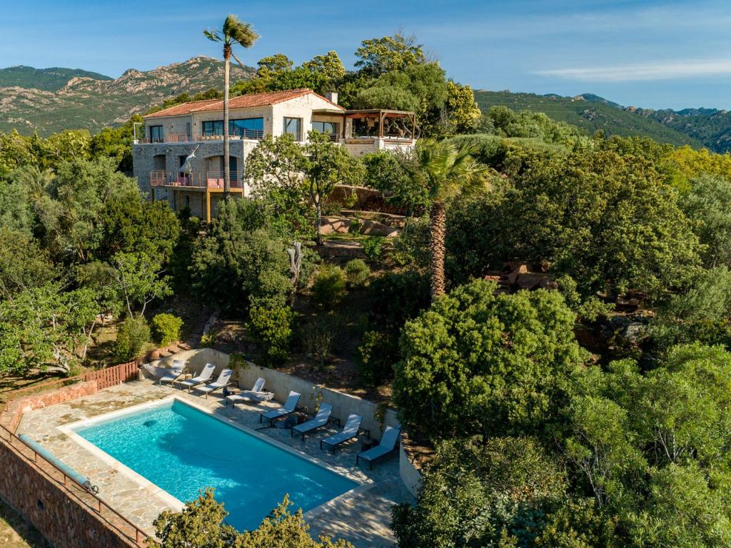 an aerial view of a house with a swimming pool at Villa L'Arbousière in Porto-Vecchio