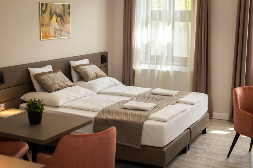 Postel nebo postele na pokoji v ubytování Végvár Spa Apartman