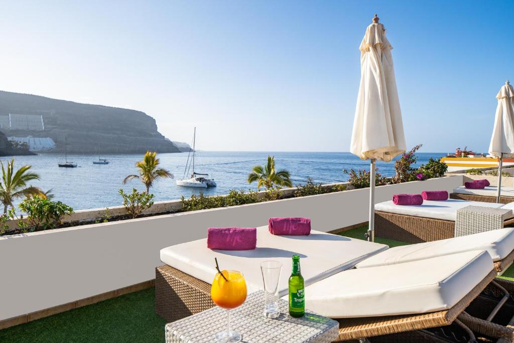 a view of the ocean from a hotel patio at Hotel LIVVO Puerto de Mogán in Puerto de Mogán