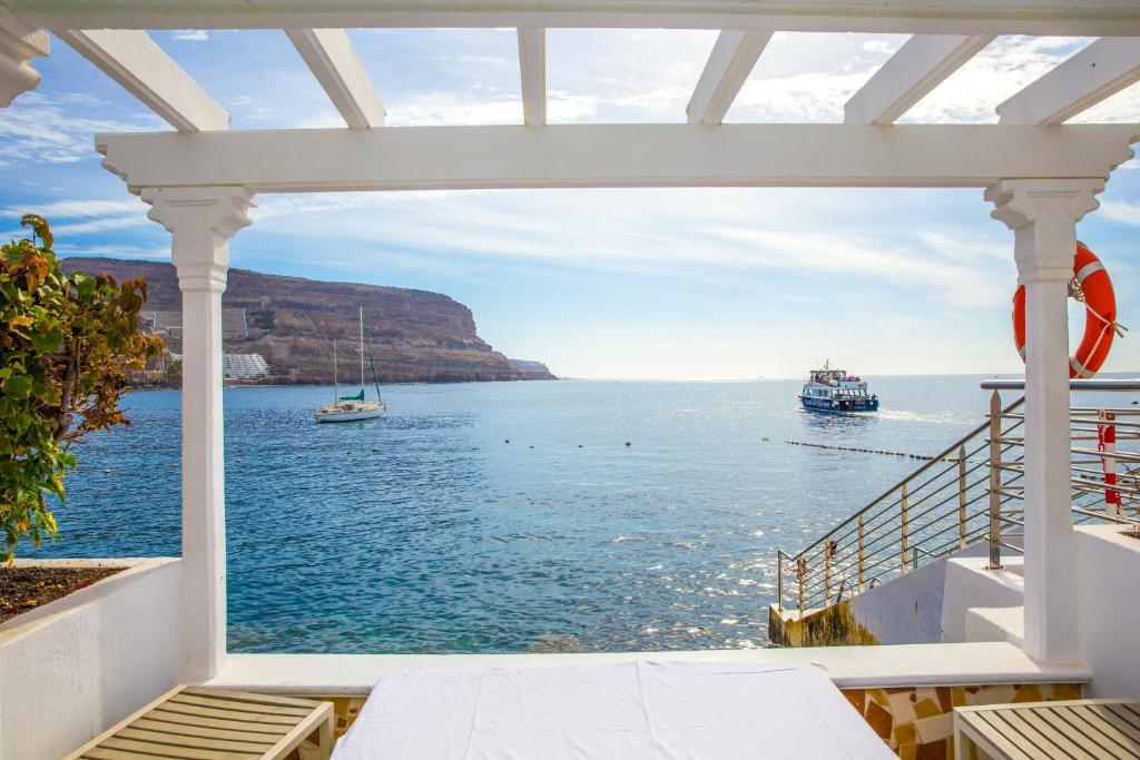 a view of the ocean from a house balcony at Hotel LIVVO Puerto de Mogán in Puerto de Mogán