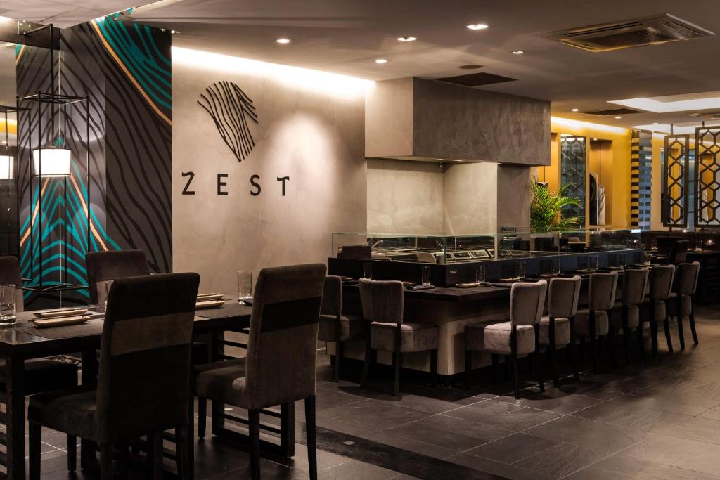 a restaurant with tables and chairs and a bar at Hotel Juliani - Boutique Hotel in St. Julianʼs