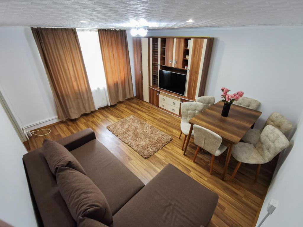 a living room with a couch and a table at Apartament Dilama Sinaia in Sinaia
