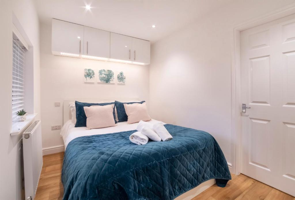 a bedroom with a bed with a blue blanket at Henry Court Apartment 1 in York