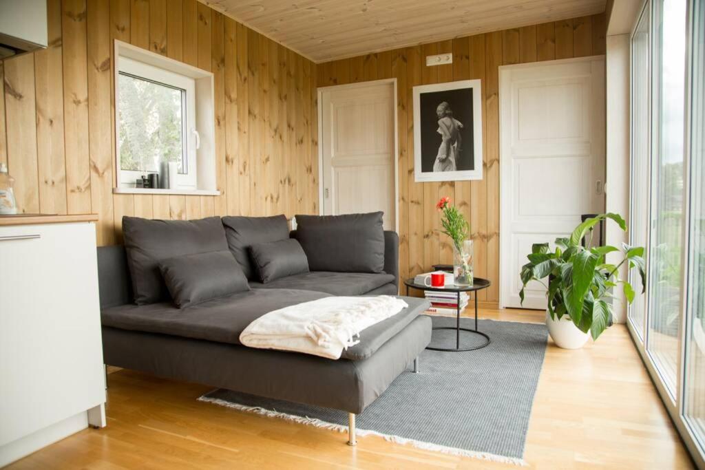 a living room with a couch and a table at Cosy house by lake in Saku