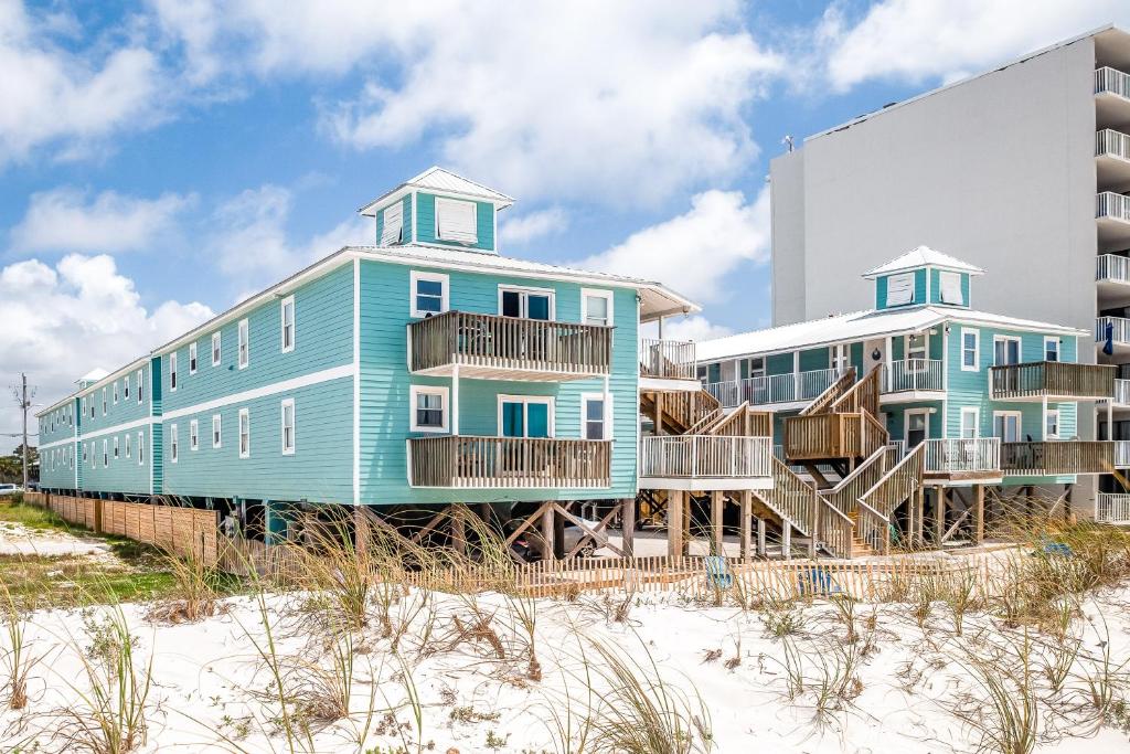 a building on the beach next to a building at Sunrise Village #209 in Gulf Shores