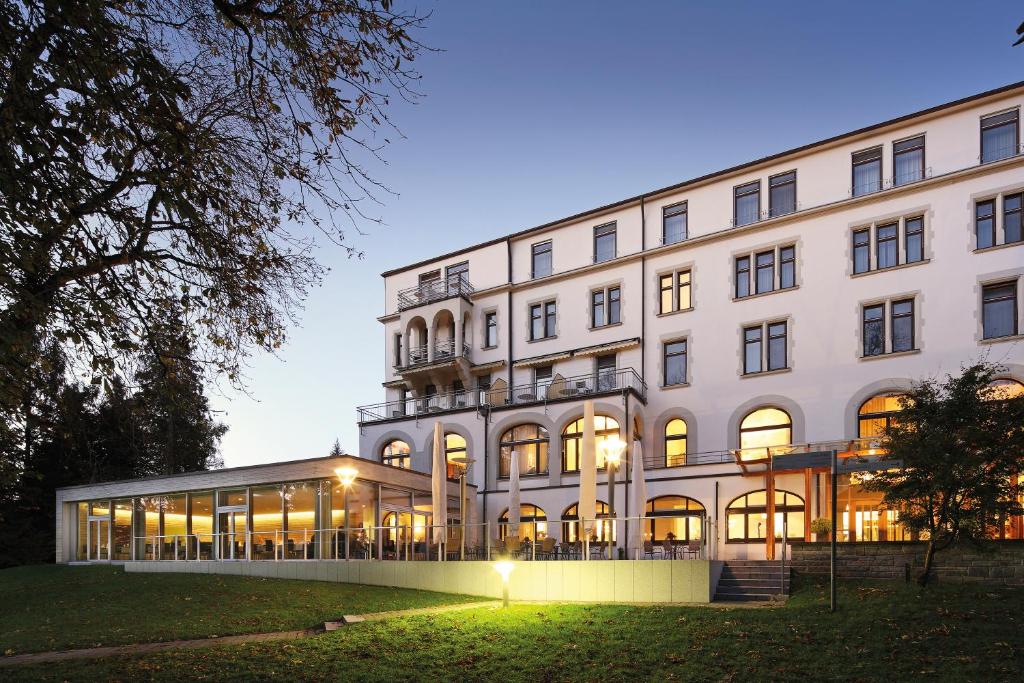 a large white building with a lot of windows at Parkhotel Jordanbad in Biberach an der Riß