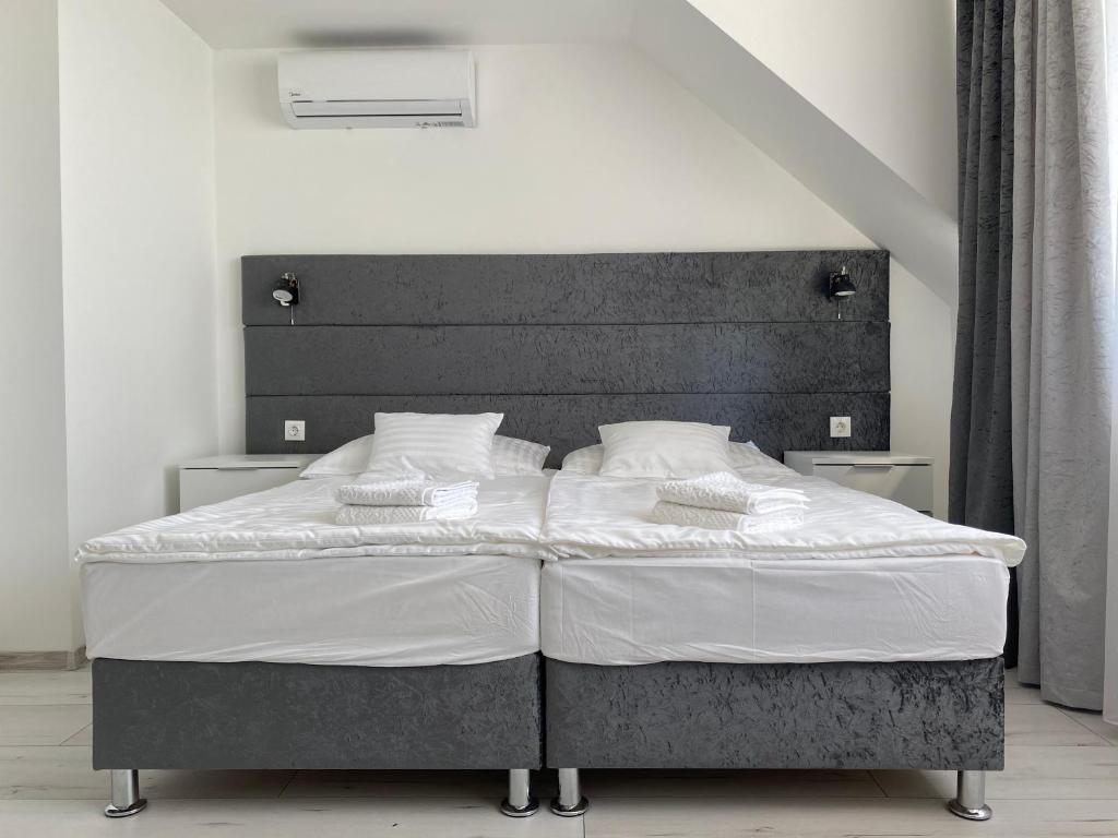 A bed or beds in a room at Q-Panzió
