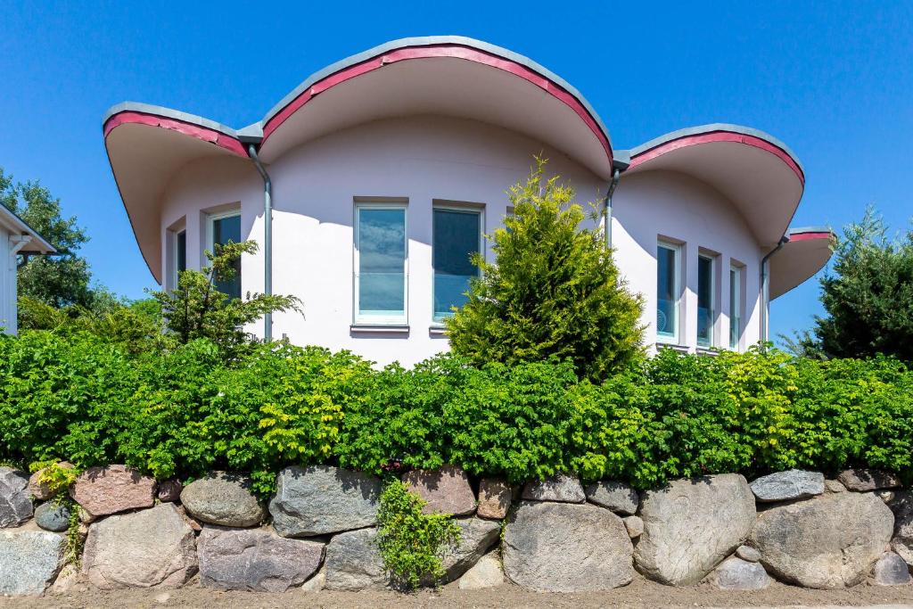 a house with a weird roof on top of a stone wall at Muschel 2 in Ahrenshoop