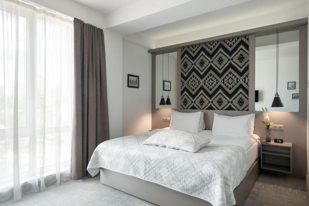 Postel nebo postele na pokoji v ubytování Thomas Albert Hotel