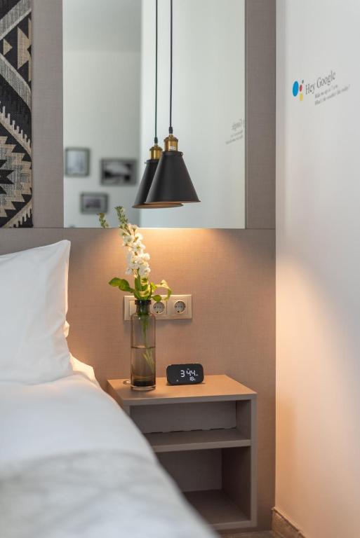 Postel nebo postele na pokoji v ubytování Thomas Albert Hotel