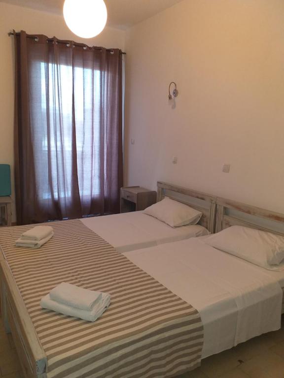 Postel nebo postele na pokoji v ubytování Ψιλή Άμμος