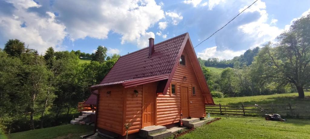 a small wooden cabin in a field with trees at Brvnara Jahorinka in Jahorina