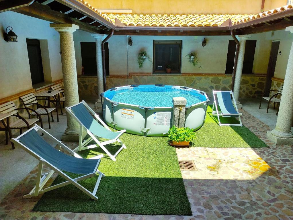 a patio with chairs and a swimming pool at Los Laureles 2 in Urda