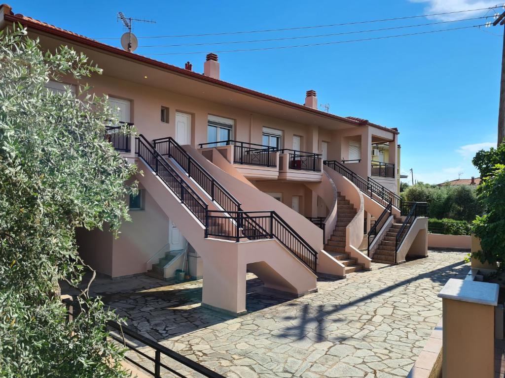 a building with stairs on the side of it at Villa Keramidi in Limenaria