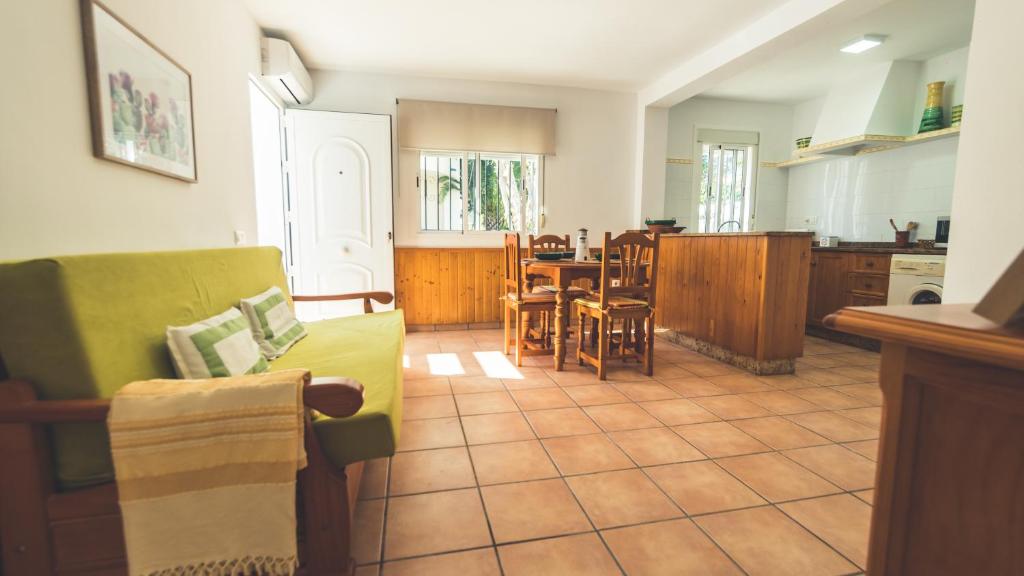 a kitchen and a living room with a couch and a table at Casa Coral - San José in San José
