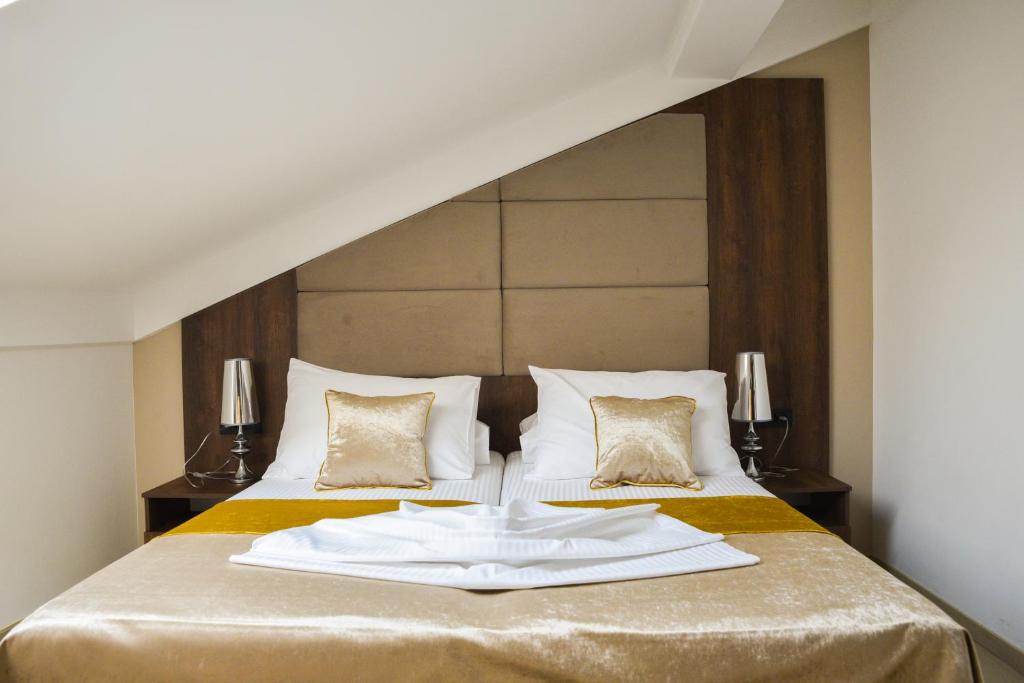 a hotel room with a bed with a towel on it at Hotel Meduza in Senj