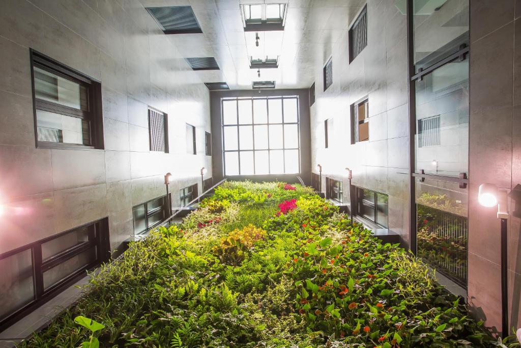 a large room with a garden in a building at Hotel Brö-Adults Recommended in Málaga