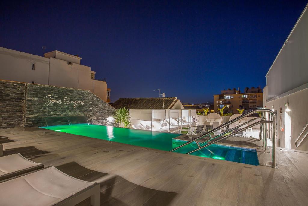 a swimming pool in a villa at night at Hotel Brö-Adults Recommended in Málaga