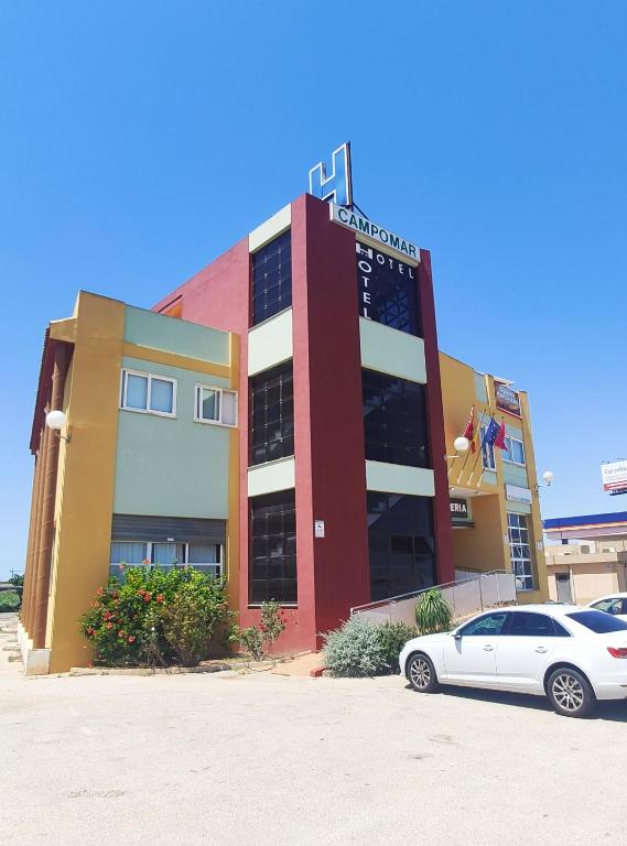 a building with a car parked in front of it at Hotel Restaurante Campomar in Cartagena