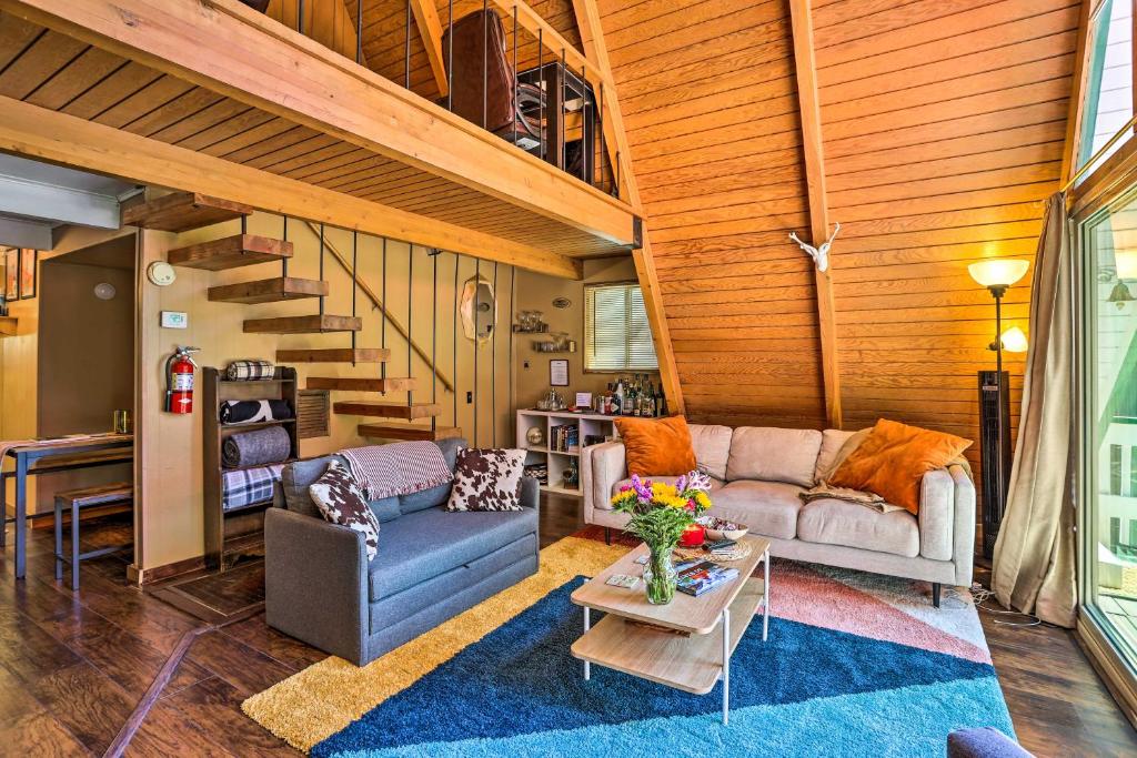 a living room with a couch and a table at Running Springs A-Frame with Deck and Mtn Views! in Running Springs
